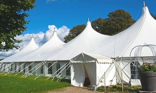 tall green portable restrooms assembled at a music festival, contributing to an organized and sanitary environment for guests in Novato